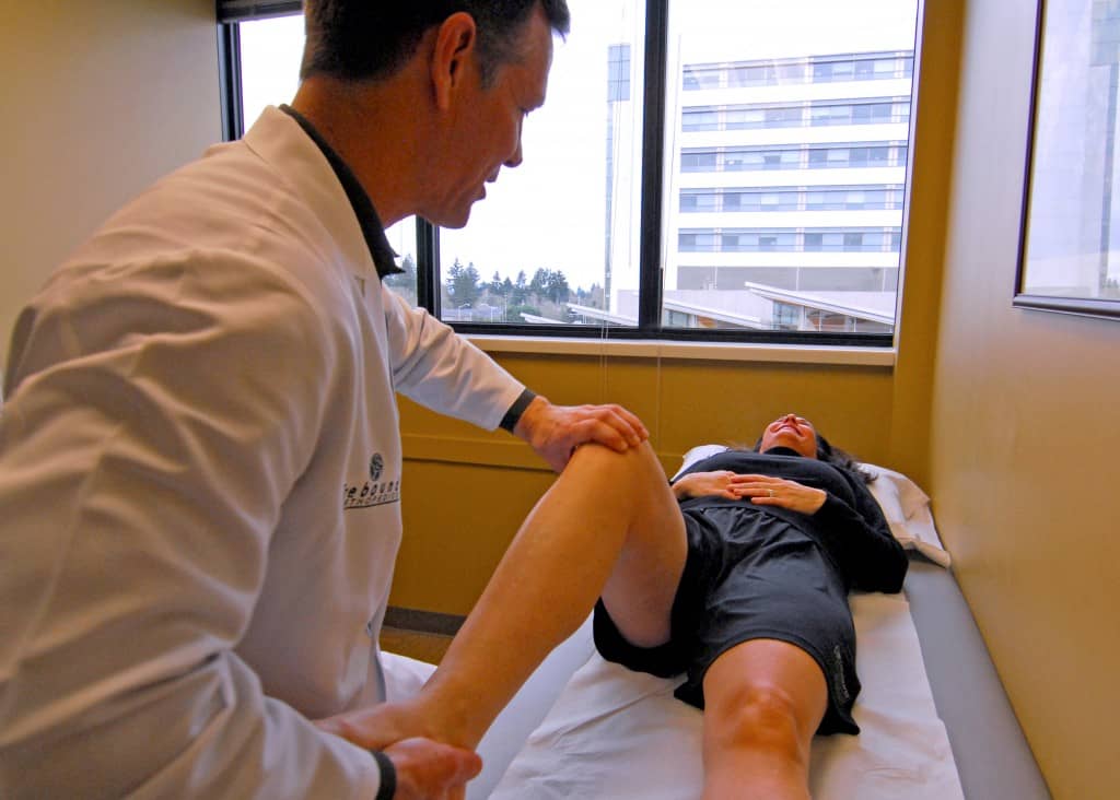 doctor helping female patient