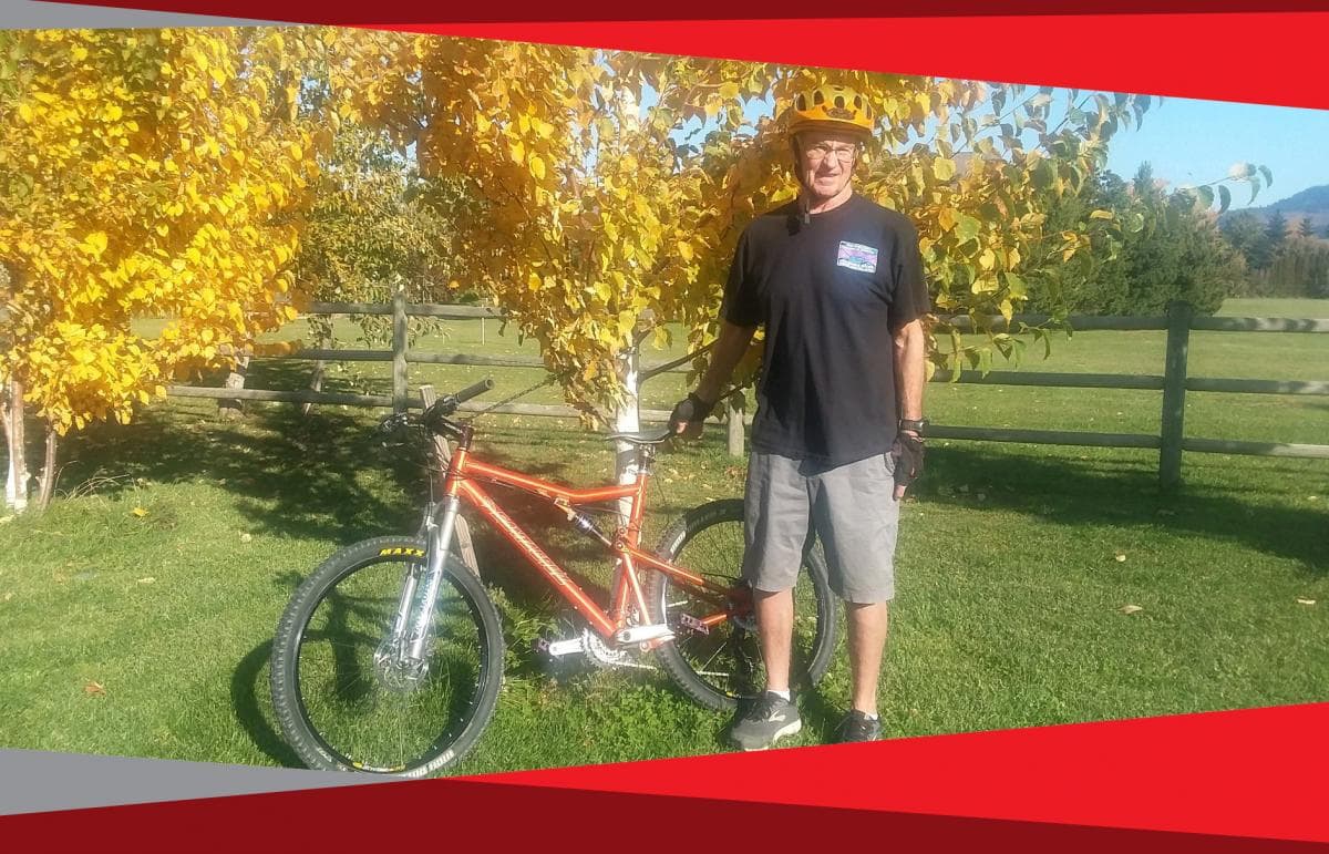 patient standing next to mountain bike