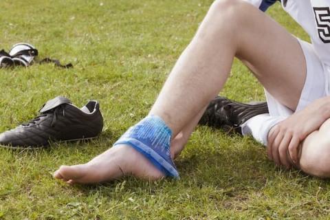 Woman icing painful ankle